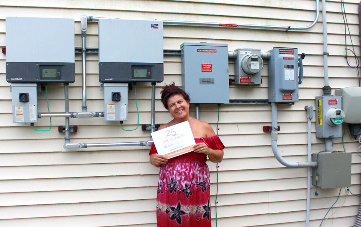 Woman in front of solar panel boxes