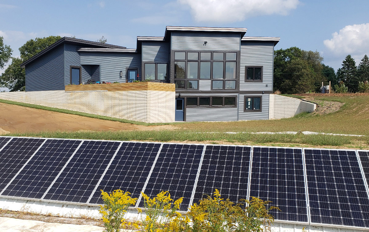 Solar panels with house in background